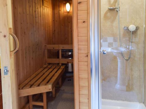 a sauna with a bench next to a sink at Catkin Lodge - Uk39646 in Lunga