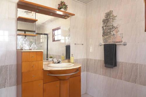 a bathroom with a sink and a mirror at Blue Primavera in Oranjestad