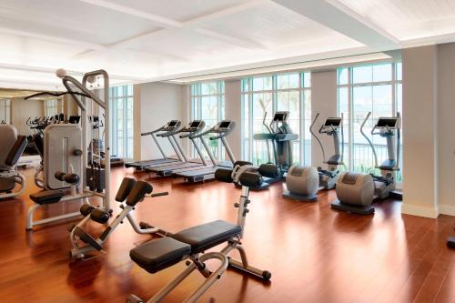 a gym with a lot of treadmills and exercise bikes at The St. Regis Abu Dhabi in Abu Dhabi