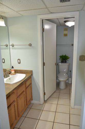 a bathroom with a sink and a toilet at Gulf front condo in Panama City Beach