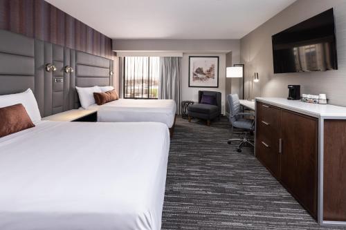a hotel room with two beds and a desk at J Resort in Reno