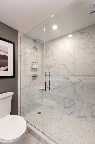 a bathroom with a glass shower with a toilet at J Resort in Reno