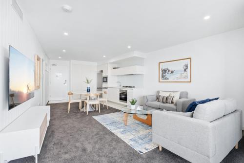 a living room with a couch and a table at Oracle Resort Broadbeach - gclr in Gold Coast