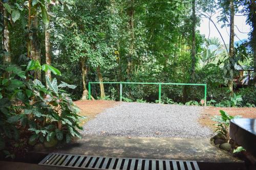 a gate in the middle of a park with trees at Arenal Descanso in Fortuna