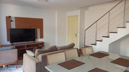 a living room with a couch and a television at Apartment Neo 2.0 in Maceió