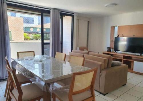 a living room with a glass table and a couch at Apartment Neo 2.0 in Maceió