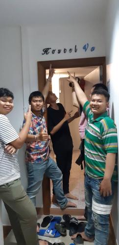a group of people standing in a room with their arms in the air at Klai Hat Inn in Hua Hin