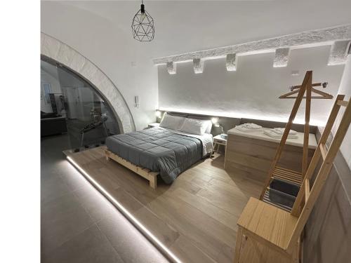 a bedroom with a bed and a staircase in it at Archome Luxury Apartment in Brindisi