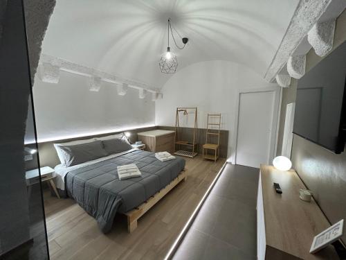 a bedroom with a bed and a tv in it at Archome Luxury Apartment in Brindisi