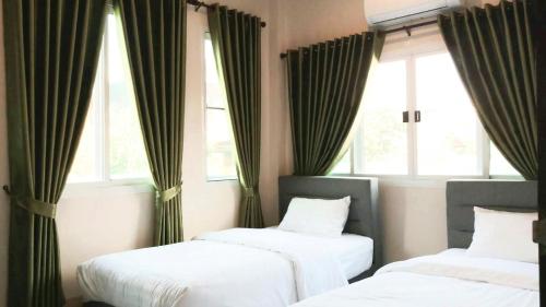 En eller flere senge i et værelse på Kantry's House กัญญ์ทรี่ เฮ้าท์