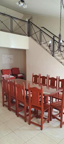 a dining room with a table and wooden chairs at La Ñata in Chicoana