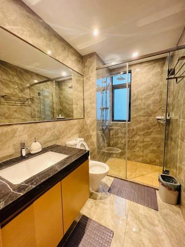a bathroom with a tub and a sink and a shower at R&F PRINCESS COVE at ANJU in Johor Bahru