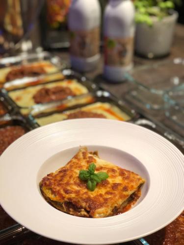 a slice of pizza on a white plate on a table at perfect lifestyle Design Boutique & Private SPA in Gebenstorf
