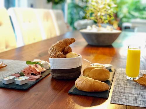 a table with a bunch of pastries and orange juice at perfect lifestyle Design Boutique & Private SPA in Gebenstorf