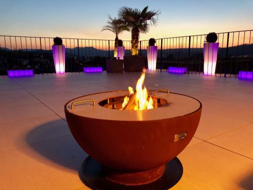 a fire pit in a courtyard with purple lights at perfect lifestyle Design Boutique & Private SPA in Gebenstorf