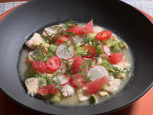 a bowl of food with tomatoes and other vegetables at perfect lifestyle Design Boutique & Private SPA in Gebenstorf