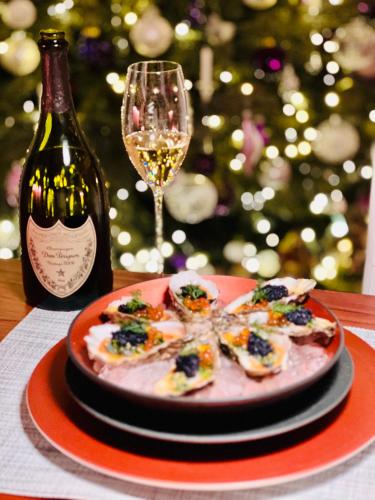 a plate of food and a bottle of wine and a wine glass at perfect lifestyle Design Boutique & Private SPA in Gebenstorf