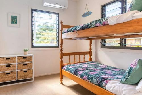 a bedroom with bunk beds in a house at Eagles Nest Two Bed Home Nudgee Beach in Brighton