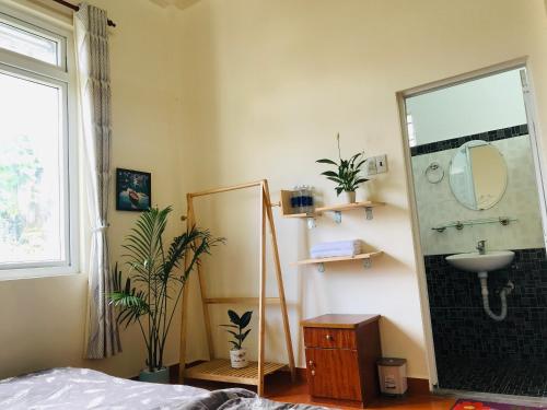 a bathroom with a sink and a mirror at NHỚ House V in Da Lat