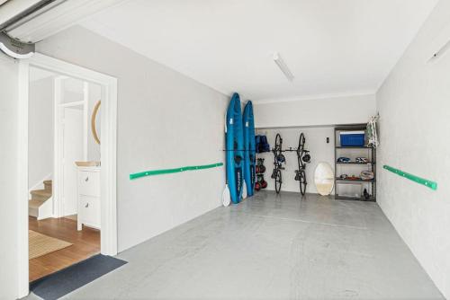 a hallway with a room with a surfboard on the wall at The Sail House at Seacliff in Seacliff