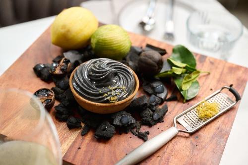 a wooden cutting board with a bowl of chocolate on top at Kyah in Blackheath