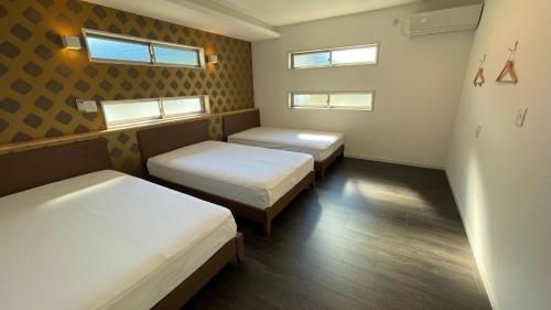 Krevet ili kreveti u jedinici u okviru objekta Nishikata Beach House 2 -西方海岸貸別荘 弐号-