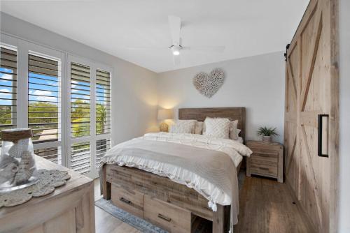 a bedroom with a large bed and a window at Peninsula Retreat in Rye