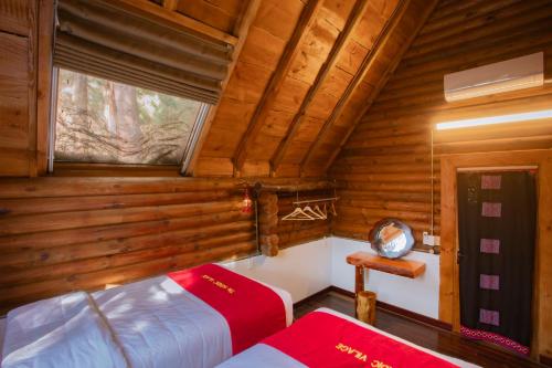 a bedroom with a bed and a window in a cabin at The Nordic Village - Evergreen Retreat in Mộc Châu