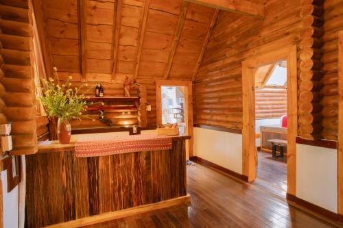 a log cabin with a bar in a room at The Nordic Village - Evergreen Retreat in Mộc Châu