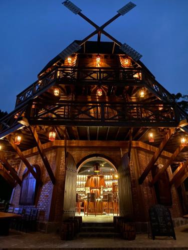 a wooden building with a table and chairs in it at The Nordic Village - Evergreen Retreat in Mộc Châu