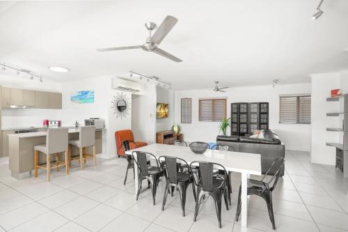 a kitchen and living room with a table and chairs at Belle Escapes 404 The Edge with Views in Cairns