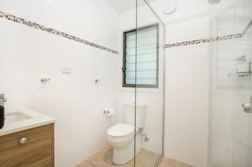 a bathroom with a toilet and a glass shower at Rest Pet Friendly with Outdoor Bath 3 Mins Walk to Beach in Umina