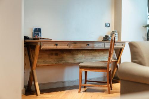 a wooden desk with a chair next to a room at THEA Private Suites by TH District in Bangkok
