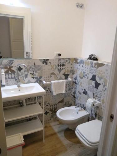 a bathroom with a sink and a toilet at Affittacamere Iris in Trieste