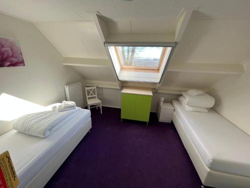 En eller flere senge i et værelse på Vakantiehuis de Turfvaart