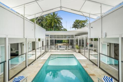 an exterior view of a house with a swimming pool at Belle Escapes Villa Rosa just minutes to Trinity Beach in Trinity Beach