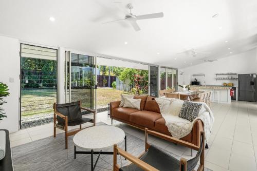a living room with a couch and a table at Belle Escapes Villa Rosa just minutes to Trinity Beach in Trinity Beach