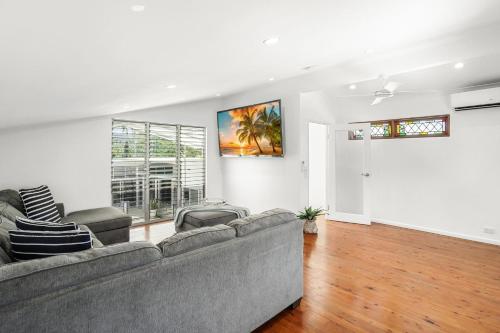 a living room with a couch and a window at Belle Escapes Villa Rosa just minutes to Trinity Beach in Trinity Beach