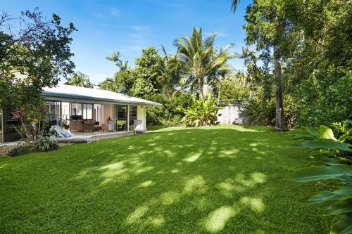 a yard in front of a house with trees at Belle Escapes Villa Rosa just minutes to Trinity Beach in Trinity Beach