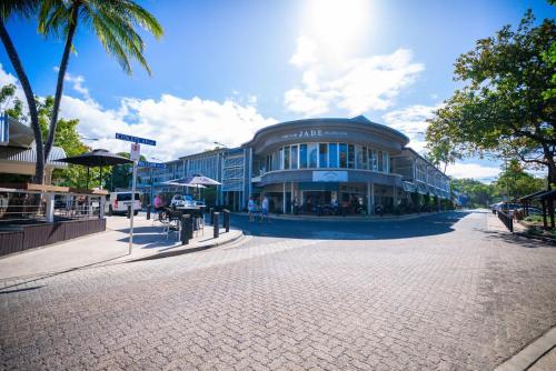 a large building on a street in a city at Belle Escapes Villa Rosa just minutes to Trinity Beach in Trinity Beach