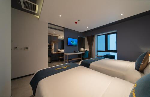 a hotel room with two beds and a television at The Time Hotel in Nha Trang