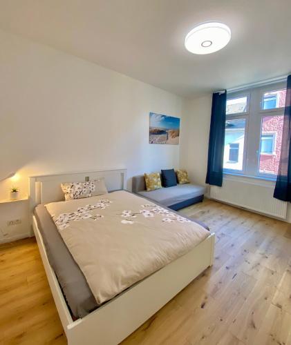 ein Schlafzimmer mit einem Bett und einem Sofa darin in der Unterkunft PnT home-stilvolles Apartment in Koblenz
