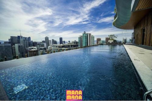 a swimming pool on the roof of a building with a city at Ceylonz KLCC by Mana-Mana in Kuala Lumpur