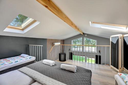 a bedroom with two beds and a large window at Soul Camp Nowęcin in Łeba