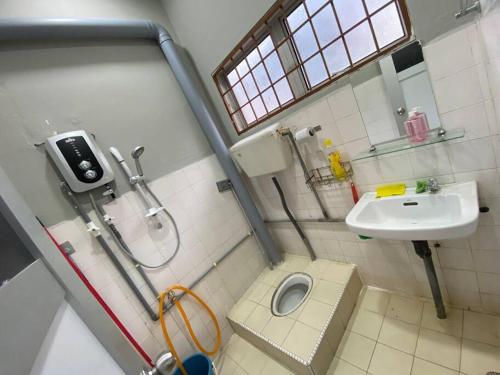a bathroom with a shower and a sink and a toilet at Entire House . 4 beds . EE Summer Guest House in Seremban