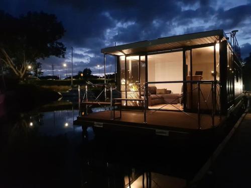 a small house on a boat in the water at Modern, brand new houseboat near Amsterdam in Monnickendam