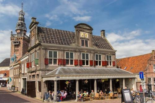 a building with a clock tower on top of it at Modern, brand new houseboat near Amsterdam in Monnickendam