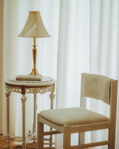 a lamp on a table next to a chair at Kallithea INN in Platres