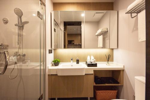 a bathroom with a sink and a shower at CM Serviced Apartment Shenzhen Dongmen in Shenzhen