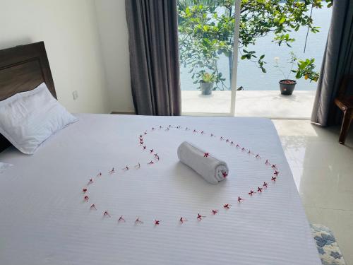 a heart made out of red stars on a bed at New Heaven in Ambalangoda